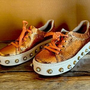 SCHUTZ shiny tennis shoes with spiked sole edges. UNIQUE